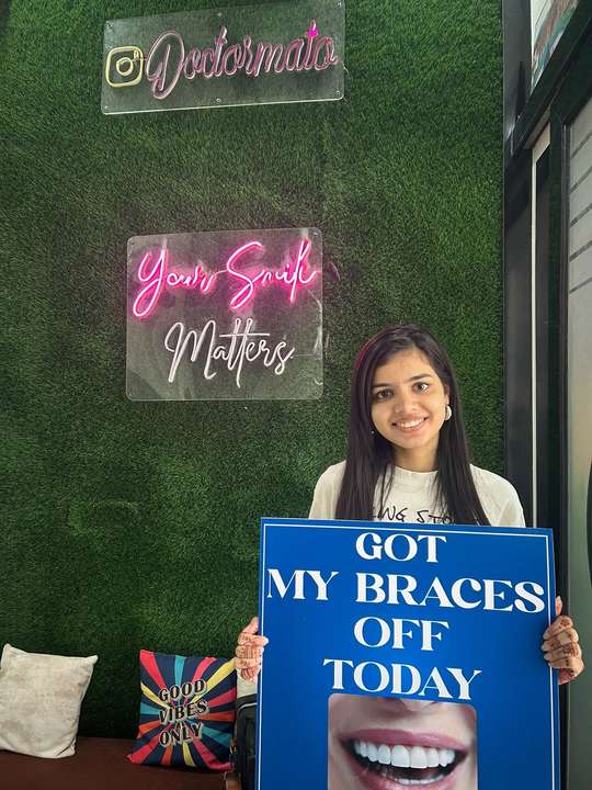 A patient celebrating the day her braces came off