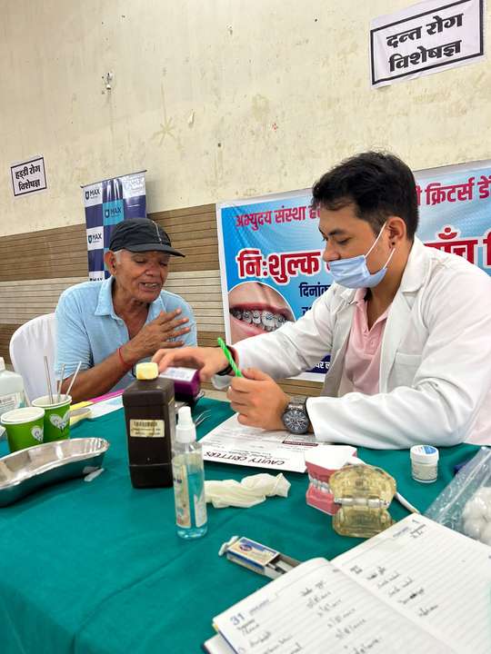 Dr. Gaurav Martolia advising a patient at the dental camp