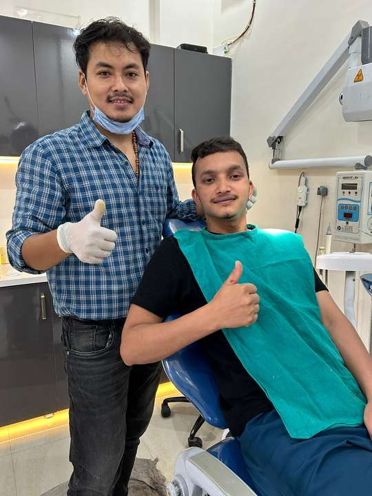 Dr. Gaurav Martolia with a smiling patient after treatment